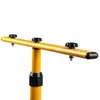 A close-up of a yellow adjustable stand with black knobs. Náhled obrázku produktu