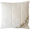 A white quilted pillow with a label wrapped around the corner. Produktbild-Vorschau
