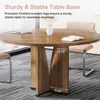A round wooden conference table with a laptop and a book on it, in an office setting. Anteprima dell’immagine prodotto