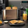 A modern kitchen counter scene featuring a copper toaster with toast, orange slices, and a glass of orange juice. Voir les images du produit