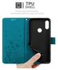A hand is shown holding open a teal flip phone case, revealing the black TPU shell inside. The case has a floral and butterfly design. Náhled obrázku produktu