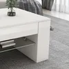 A close-up view of a white coffee table with a glass shelf and books. Náhled obrázku produktu