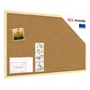 A cork bulletin board with a natural wood frame, displayed at an angle against a white background. It has a small photo, some icons, and a "MORE SIZES" card attached. Náhled obrázku produktu