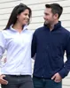 A man and a woman standing next to each other, looking at each other, in front of a light-colored, horizontally paneled wall. Produktbild-Vorschau