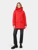 A woman wearing a red parka and black jeans, standing against a white background. Produktbild-Vorschau