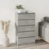 A chest of drawers next to a sofa, with decorative items on top. Náhled obrázku produktu