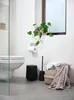 A modern bathroom scene with a toilet, toilet brush, trash can, and a basket of towels. Produktbild-Vorschau