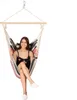 A woman is sitting in a hammock chair. Podgląd zdjęcia produktu