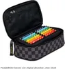 An open pencil case filled with colored pencils on a white background. Produktbild-Vorschau