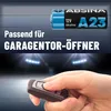 A hand holding a car key fob in front of a blurred background of stadium lights and a garage door. Produktbild-Vorschau