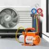 A vacuum pump and manifold gauge kit are shown in front of an air conditioning unit. Voir les images du produit