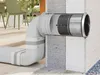 A ventilation system component is shown installed in a wall, with a connecting duct system extending to the left. Podgląd zdjęcia produktu