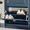 A close-up view of a blue shoe cabinet with shoes inside. Náhľad obrázku produktu
