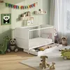 A nursery room with a white crib, stuffed animals, and decorations. Produktbild-Vorschau