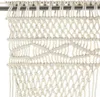 A close-up view of a cream-colored macrame curtain hanging from a metal rod. Náhľad obrázku produktu