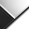 A close-up view of a black leather-bound mirror. Produktbild-Vorschau