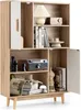 A multi-compartment sideboard with a white door and wooden accents, displaying various decorative items and books. Náhled obrázku produktu