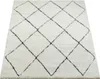 A cream-colored rug with a black diamond pattern, shown from a slightly elevated angle on a white background. Produktbild-Vorschau