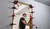A man is installing a door frame using specialized tools. Anteprima dell’immagine prodotto