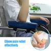 A person sitting in a chair with armrest cushions, with a close-up inset showing an elbow with pain. Náhled obrázku produktu