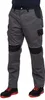 A person wearing work pants and shoes, standing against a white background. Produktbild-Vorschau