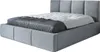 A gray upholstered bed with a mattress and bedding, shown from a side angle against a white background.