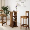 A bar table and two bar stools are set up in a room with a large plant and shelves on the wall. Anteprima dell’immagine prodotto