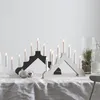 A tabletop display of two candle arches with electric candles, decorated with Christmas ornaments. Podgląd zdjęcia produktu