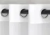 Close-up view of three white curtains with grommets on a black curtain rod. Produktbild-Vorschau