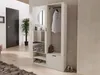 An entryway with a wardrobe, mirror, and coat rack. A dark door is on the left, and a plant is in a pot. Produktbild-Vorschau