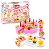 A toy birthday cake set with various accessories, including cupcakes, fruits, and serving utensils, displayed on a white background. Podgląd zdjęcia produktu
