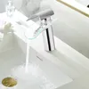 A modern chrome faucet with a glass waterfall spout is shown in a bathroom sink. Podgląd zdjęcia produktu