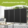 A black, four-panel room divider set up in a living space with a sofa and coffee table in the foreground and plants in the background. Anteprima dell’immagine prodotto