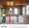 A worker uses a red drywall lift to install a panel on a wooden ceiling in an unfinished room. Náhled obrázku produktu