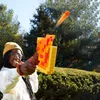 A person is playing with a toy blaster outdoors. Podgląd zdjęcia produktu