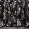 A close-up view of a black curtain with a repeating pattern of gold and silver palm leaves. Produktbild-Vorschau
