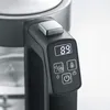Close-up of a modern electric kettle handle with a digital display and control buttons. Produktbild-Vorschau