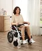 A woman is sitting in an electric wheelchair in a room. Náhľad obrázku produktu