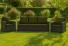 Outdoor furniture set on a green lawn with trees and bushes in the background. Produktbild-Vorschau