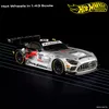 A silver and black Hot Wheels premium replica car with racing decals and sponsor logos, displayed on a black background with thin white diagonal lines. Náhľad obrázku produktu