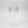 A clear glass wine glass with a decorative pattern and text on it, set against a white background. Náhľad obrázku produktu