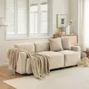 A beige sofa with a throw blanket and pillows in a living room setting. Anteprima dell’immagine prodotto