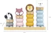 A wooden stacking toy with animal figures and numbered rings on a white and gray striped base. Produktbild-Vorschau