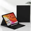 A black tablet with a keyboard case is displayed on a reflective surface with a light gray background. Náhled obrázku produktu