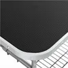 A close-up view of the corner of a grooming table, showing the textured black surface and the silver metal edge. Produktbild-Vorschau