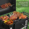 A charcoal grill with various types of meat cooking on the grates, set against a grassy background. Produktbild-Vorschau
