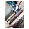 A person wearing gloves is using a reciprocating saw to cut a rusty pipe. Náhľad obrázku produktu