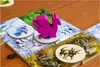 A close-up of a board game with colorful tiles and wooden game pieces. Voir les images du produit