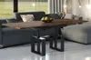 A modern living room with a sofa, coffee table, and ottoman. Produktbild-Vorschau