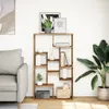 A bookshelf with books and decorative items in a living room setting next to a sofa and a large plant. Produktbild-Vorschau